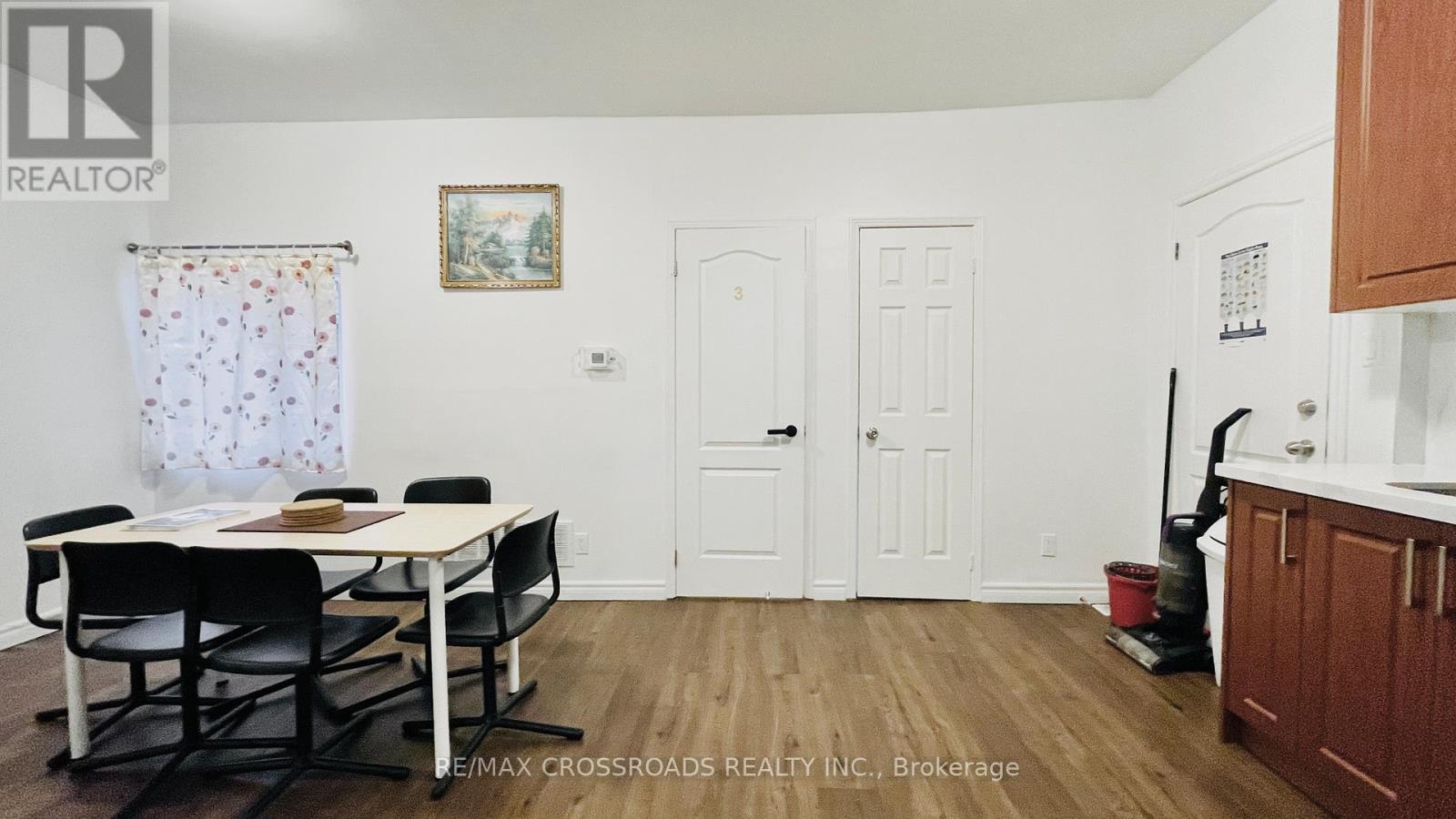 A dining room with a table and chairs.