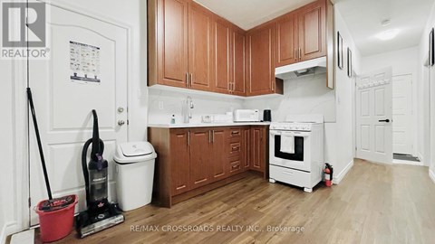 A kitchen with wooden cabinets and white appliances.