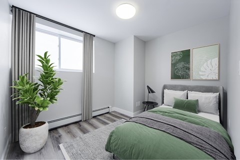 Renovated bedroom with vinyl plank flooring.