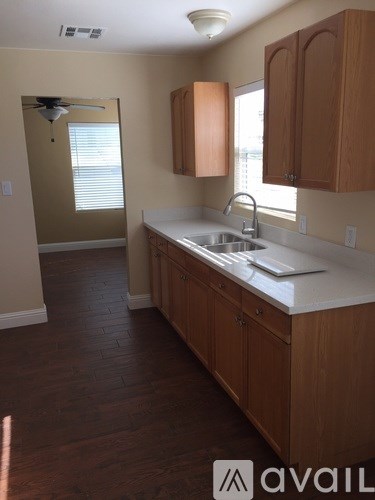 A kitchen with wooden cabinets and a white countertop.