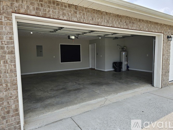 A garage with a brick wall and a white door.