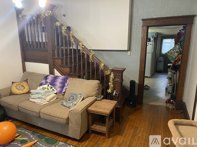 A living room with a couch and a balloon on the floor.