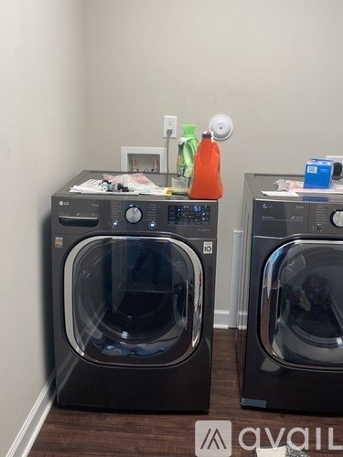 Two front load washing machines are in a laundry room.