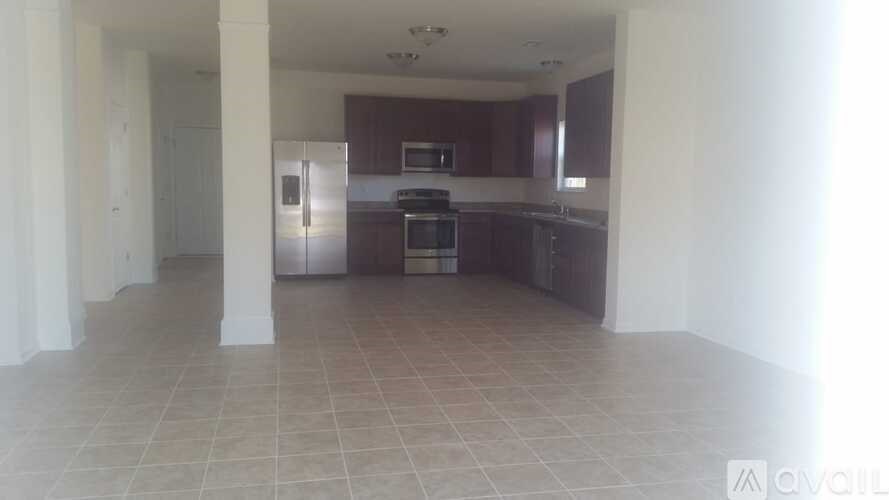 A kitchen area with a refrigerator, microwave, and oven.