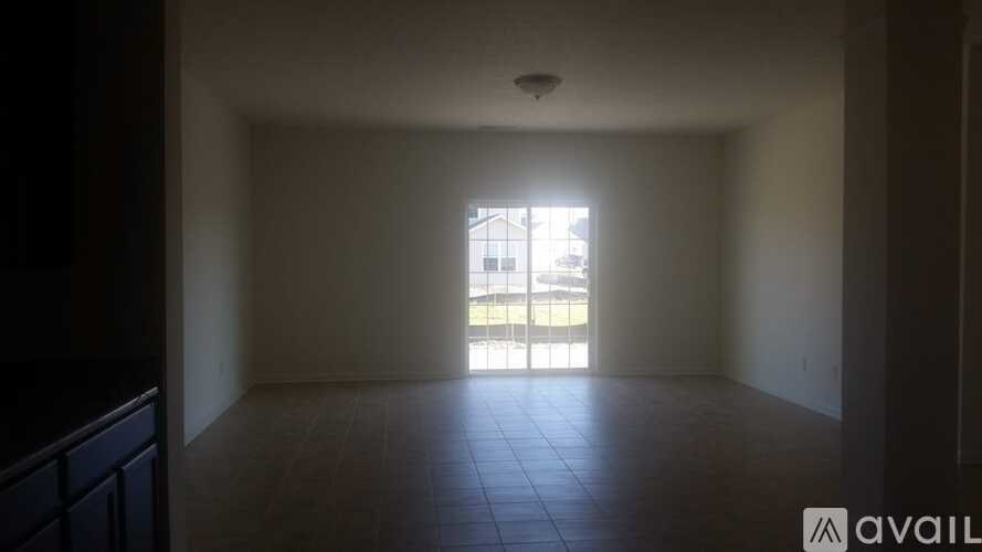 A room with a large window and tiled floor.