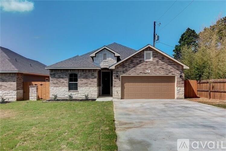 A house with a garage and a driveway is available for sale.