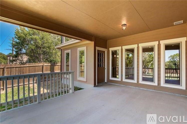 A patio area with a railing and sliding glass doors.