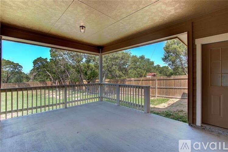 A patio with a view of a backyard and trees.