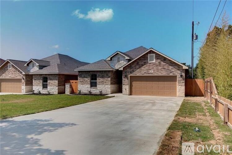 A house with a brown garage door is for sale.