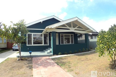 A house with a blue front and a white roof.
