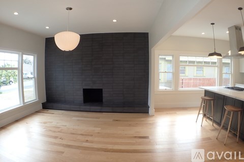 A modern living room with a fireplace and wooden floors.