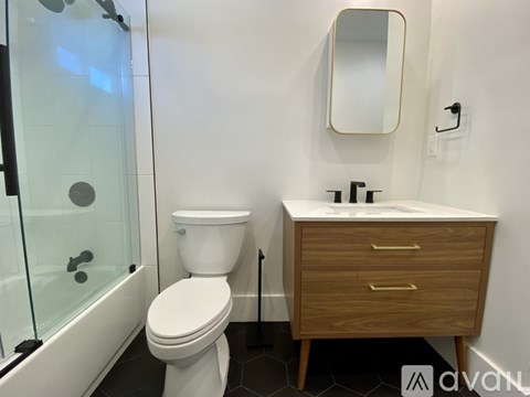 A white toilet sits next to a sink in a bathroom.