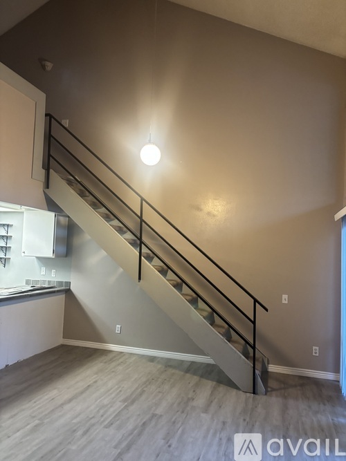 A staircase with a metal railing and wooden steps.