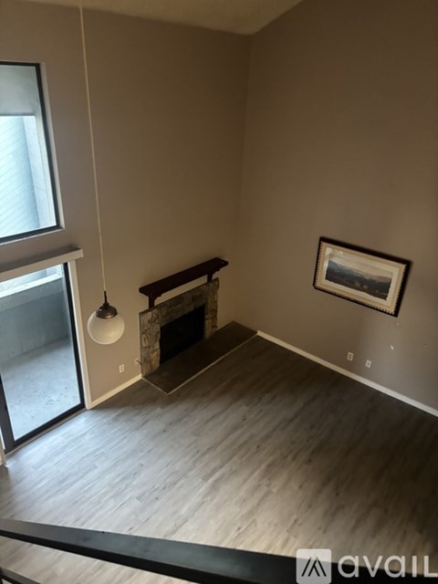 A living room with a fireplace and a painting on the wall.