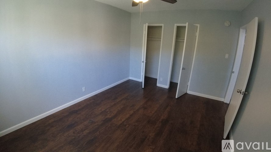 A room with wood flooring and white walls.