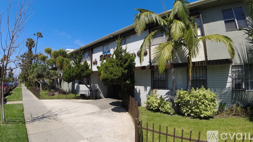 A sunny day at a residential area with apartment buildings and a clear blue sky.