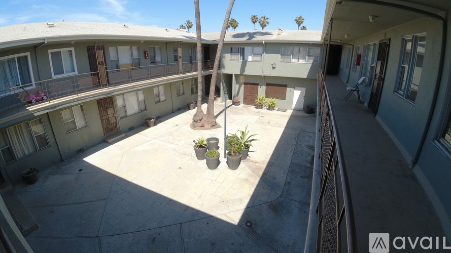 A balcony with potted plants and a view of the sky.