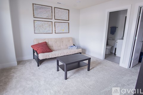 A living room with a white couch and a coffee table.