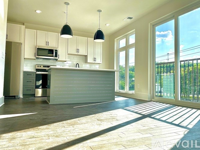 A kitchen with a large island in the middle.