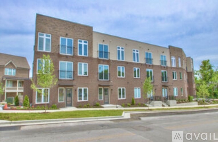 A large brick building with many windows is available for rent.