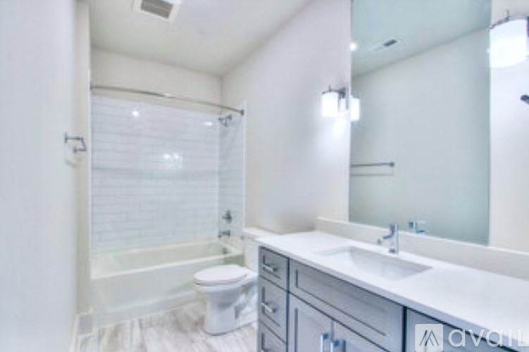 A white bathroom with a sink, toilet and bathtub.