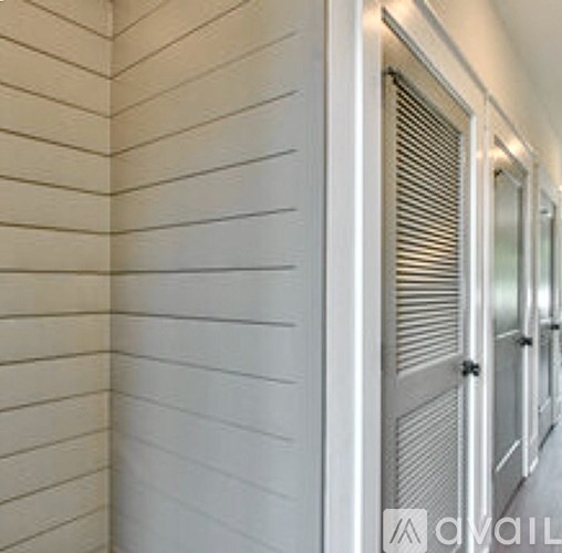 A long hallway with white walls and doors.