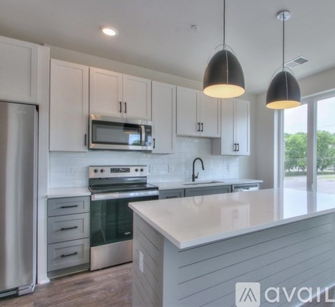 A modern kitchen with white cabinets and a large island.