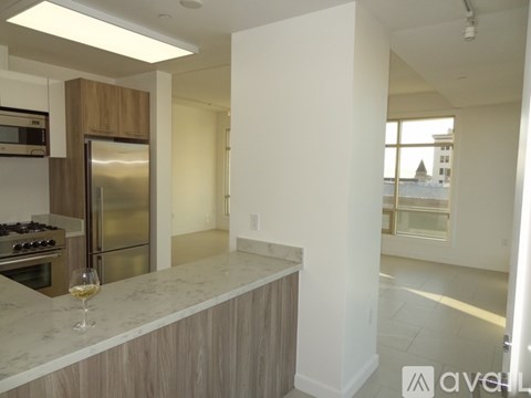 A kitchen with a marble countertop and stainless steel appliances.