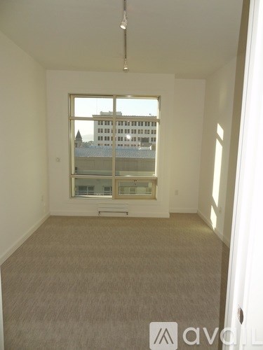 A room with a window overlooking a cityscape.