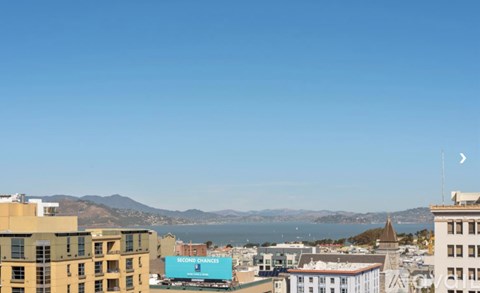 A cityscape with a clear blue sky and a sign that reads "RECORD CHANGES".