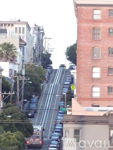 Cars are parked on the side of a street.