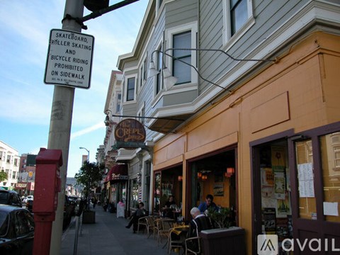 A sign on a pole that says Skateboarding, roller skating, and bicycle riding are prohibited on the sidewalk.