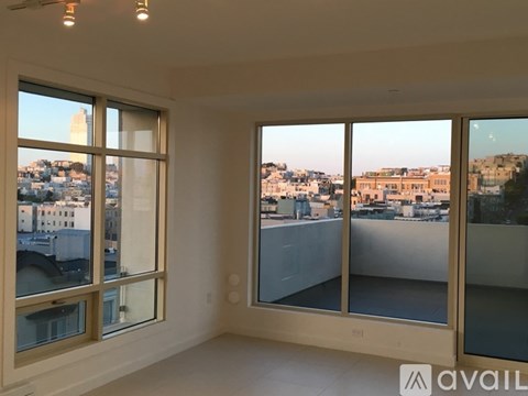 A room with large windows overlooking a cityscape.