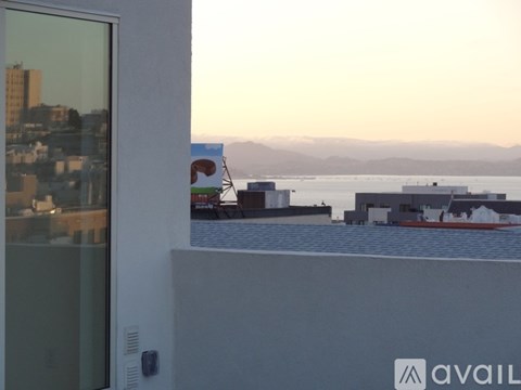 A view from a window looking out to a cityscape and a body of water.