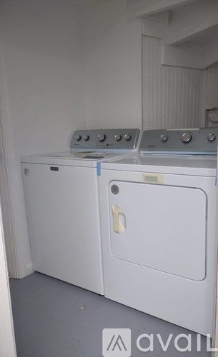 A white oven with a blue handle is in a room.