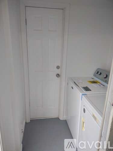 A white door with a white cabinet to the right.