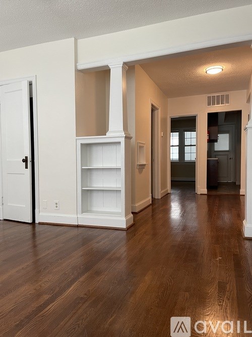 A room with wooden floors and white walls.
