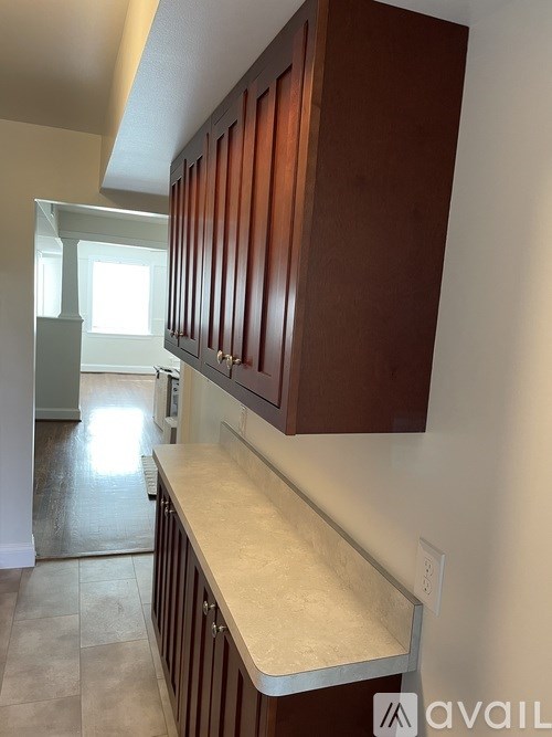 A kitchen with brown cabinets and a counter top.
