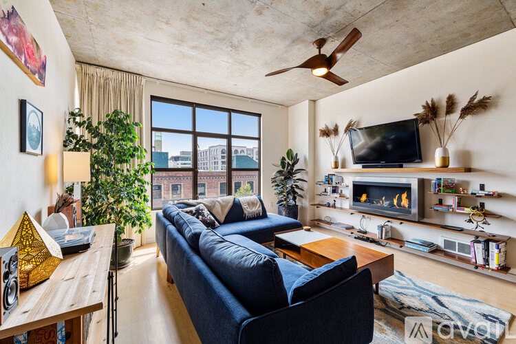 A living room with a blue couch and a television.
