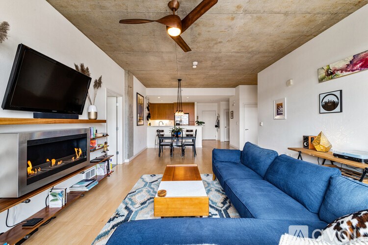 A living room with a fireplace and a television.