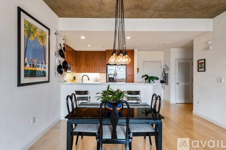 A modern dining room with a glass table and chairs.