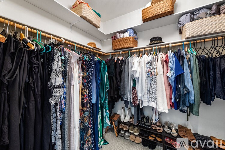 A closet full of clothes and shoes.