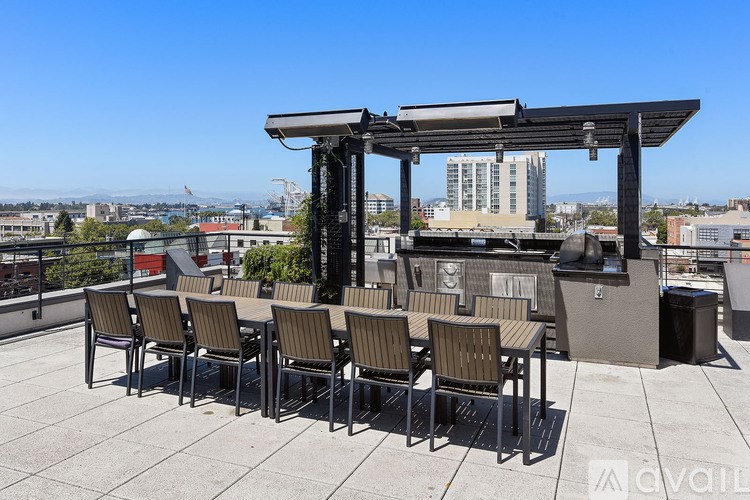 A patio with chairs and a table is set up on a rooftop.