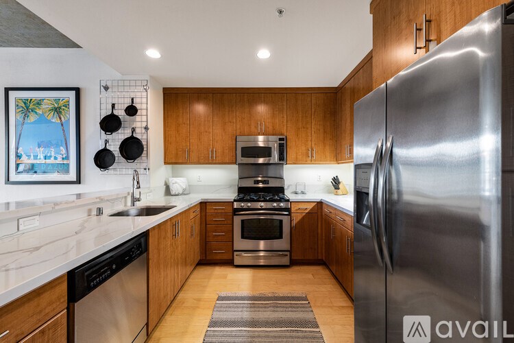 A modern kitchen with wooden cabinets and stainless steel appliances.