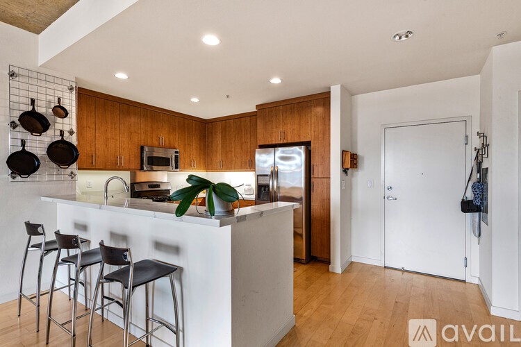 A kitchen with wooden cabinets and a white counter.