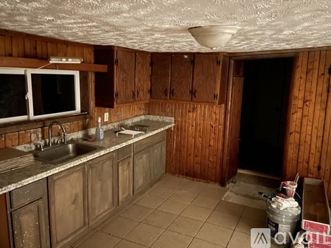 A kitchen with wooden cabinets and a sink.