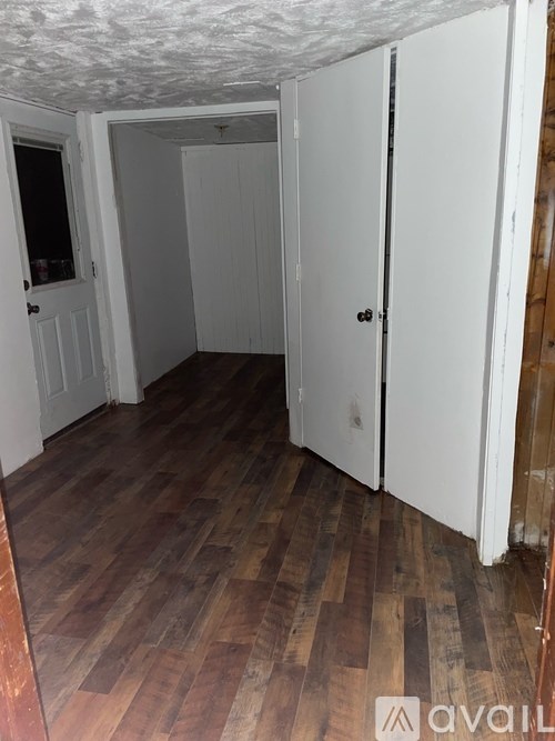 A room with wooden floors and white walls.