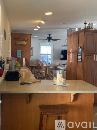 A kitchen with wooden cabinets and a counter with a candle on it.