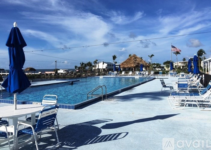 A pool area with chairs and umbrellas is available for use.
