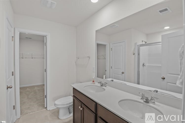 A bathroom with a white toilet and a white sink.